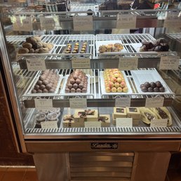 a display case filled with chocolates a display case filled with chocolates