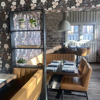 Olio - a dining area with a table and chairs - Italian Near Me - Bayport, Minnesota Olio - a dining area with a table and chairs - Italian Near Me - Bayport, Minnesota