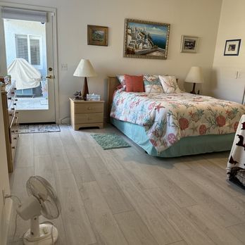 Angello's Floor Covering - a bedroom with a bed and a fan - Carpeting Near Me - Arroyo Grande, California