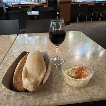 Lebanese Taverna - Warm pita with humus and a glass of wine - nice way to relax on the town square. - Middle Eastern Near Me - Rockville, Maryland Lebanese Taverna - Warm pita with humus and a glass of wine - nice way to relax on the town square. - Middle Eastern Near Me - Rockville, Maryland