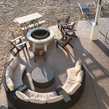 Hampton Inn & Suites Manistee Waterfront - Patio fire pit facing the beach. - Hotels Near Me - Manistee, Michigan Hampton Inn & Suites Manistee Waterfront - Patio fire pit facing the beach. - Hotels Near Me - Manistee, Michigan