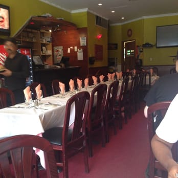 Joy Indian Restaurant - Inside the dining area. Tables for 2 can be found along the wall and in front of the restaurant - Indian Near Me - Brooklyn, New York