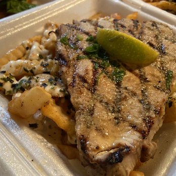 Flyin' Ahi - Ahi steak in a bed of Tsunami Fries. Normally there's salad and rice.  But the old man wanted fries! - Food Trucks Near Me - Mililani, Hawaii