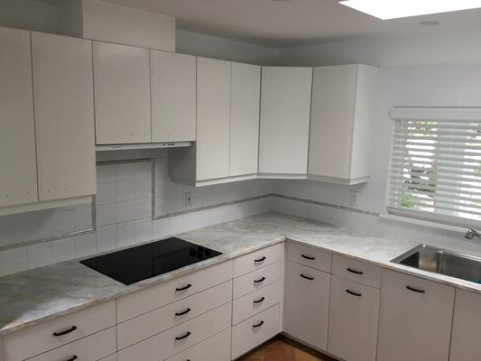 Kitchen Renewal: Light & Bright - This project refreshed a kitchen by resurfacing the countertop to white and repainting the cabinets from teal to white. The process included refinishing the countertop for a clean, durable new look, along with prepping, priming, and painting the cabinets. The result is a significantly brighter, more modern kitchen with a cohesive white aesthetic throughout. Kitchen Renewal: Light & Bright - This project refreshed a kitchen by resurfacing the countertop to white and repainting the cabinets from teal to white. The process included refinishing the countertop for a clean, durable new look, along with prepping, priming, and painting the cabinets. The result is a significantly brighter, more modern kitchen with a cohesive white aesthetic throughout.