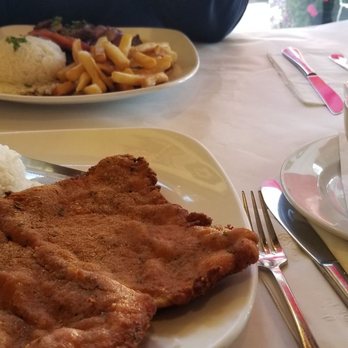 MACA Peruvian Restaurant - In the foreground Milanesa de pollo Arroz Blanco frijoles and Lomo Saltado. - Peruvian Near Me - Rego Park, New York