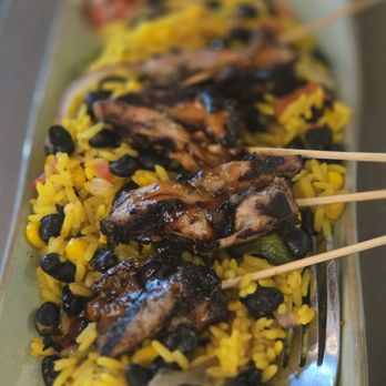 Babalu - Chicken on a stick over bed of yellow rice I think - Salad Near Me - Memphis, Tennessee