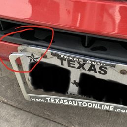 Broken license plate holder after exiting the wash