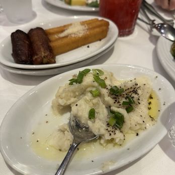 Fogo de Chão - Condiments (butter mash potatoes with chives, fried plantain, and fries) Cocktail: berry hibiscus mixed - Brazilian Near Me - The Woodlands, Texas