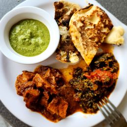 a plate of food with a bowl of sauce