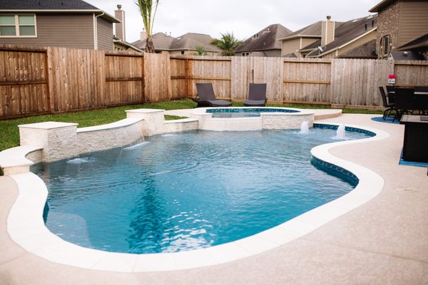 Chic Contemporary Freeform Pool/Spa - Avree Custom Pools has been creating backyard retreats for decades, transforming outdoor spaces into an oasis that can be enjoyed year-round. Designing and building projects that fit your lifestyle and unique preferences with excellence is our mission.