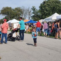 Sugar Mound Arts & Crafts - People strolling through the show past booths of yard art