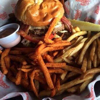 Bubba's 33 - Guacamole bacon burger with half sweet potato fries.  The bun is butter brushed, the cheese oozy, the fries hot but heavy with frying oil. - Pizza Near Me - Colorado Springs, Colorado