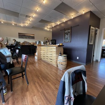 The Wine Spot - a woman sitting at a table - Wine Bars Near Me - Edgewood, Washington