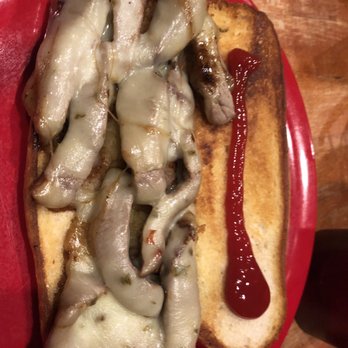 Burnout Grill - a hot dog with onions and ketchup - New American Near Me - Milliken, Colorado
