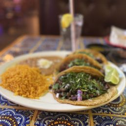 Asada, pastor and carnitas tacos, rice and beans.