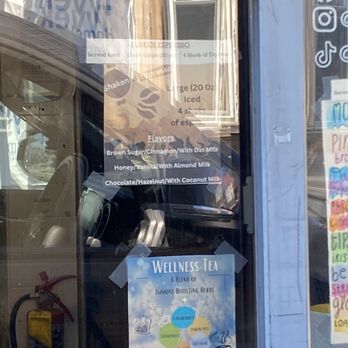 Coffee Express - Menu - The window features a menu for espresso beverages and a poster promoting wellness teas with immune-boosting herbs. - Coffee & Tea Near Me - Bangor, Maine