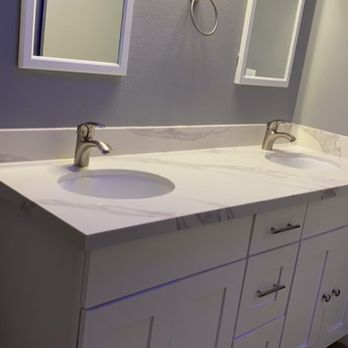 Phoenix Quality Construction - New cabinets , installation of quartz countertops & backsplash, new sink and replacement of flooring to LVP - Roofing Near Me