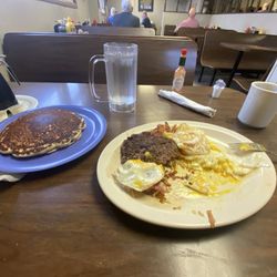 Cowboy Cafe - Chopped steak with eggs, hash brown and pancake with a coffee and water.