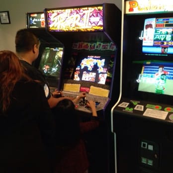 Neon Retro Arcade - Father teaching his daughter Street Fighter II. - Arcades Near Me - Pasadena, California