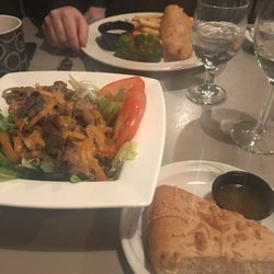Ivan's Restaurant - Foreground: steak salad and accompanying focaccia bread. Background: fish and chips.