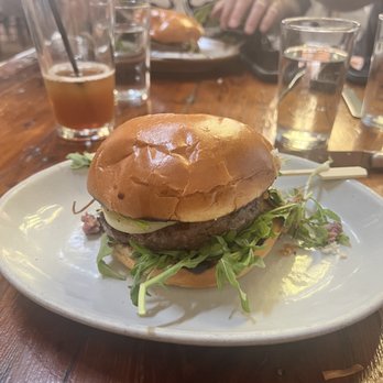 Manuela - Venison Burger, Pickled Green Tomato, Arugula, Crisp Leeks, Garlic Aioli, Brioche Bun - New American Near Me - Los Angeles, California Manuela - Venison Burger, Pickled Green Tomato, Arugula, Crisp Leeks, Garlic Aioli, Brioche Bun - New American Near Me - Los Angeles, California