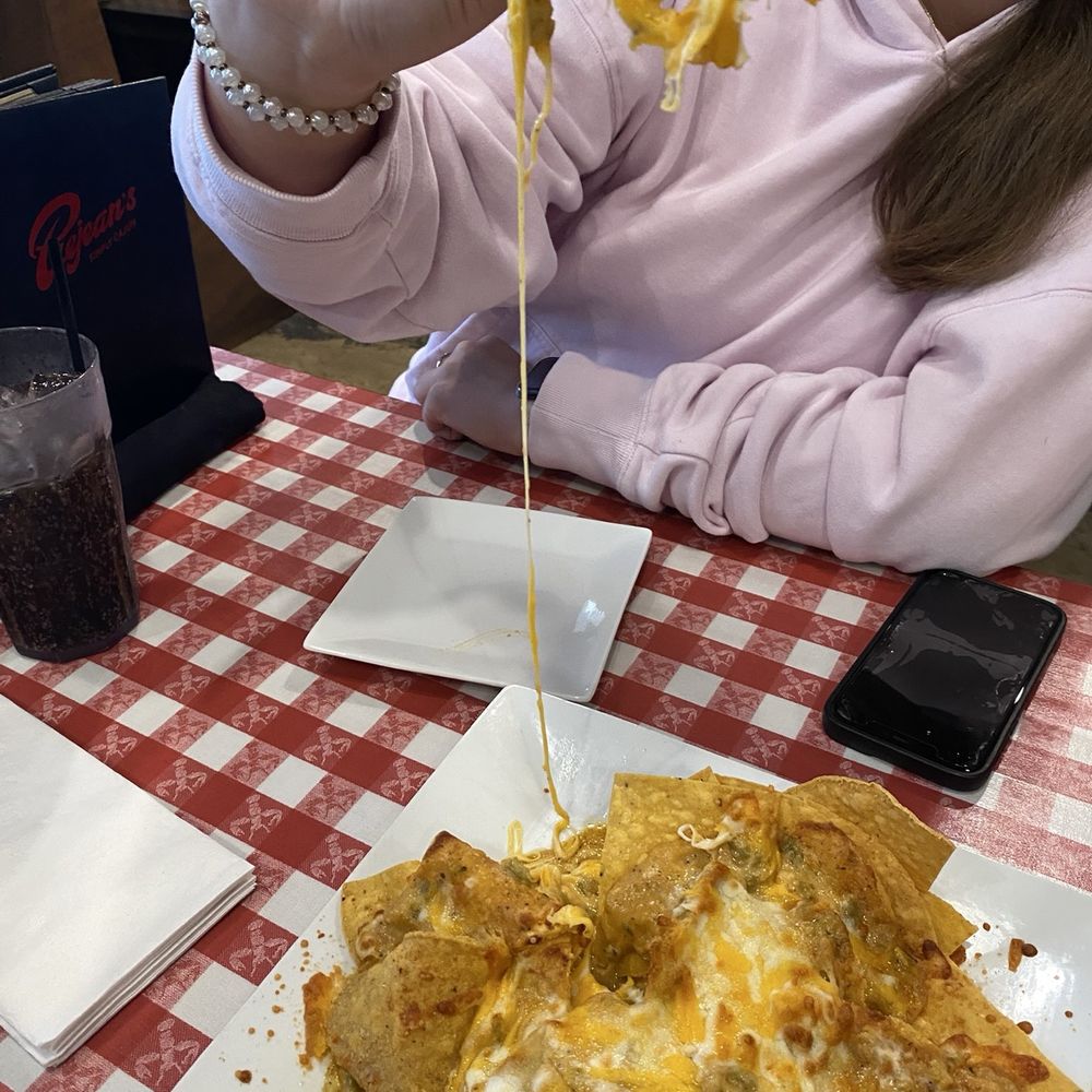 Prejean's - Cheese pull on the Crawfish Nachos - Cajun/Creole Near Me - Broussard, Louisiana Prejean's - Cheese pull on the Crawfish Nachos - Cajun/Creole Near Me - Broussard, Louisiana