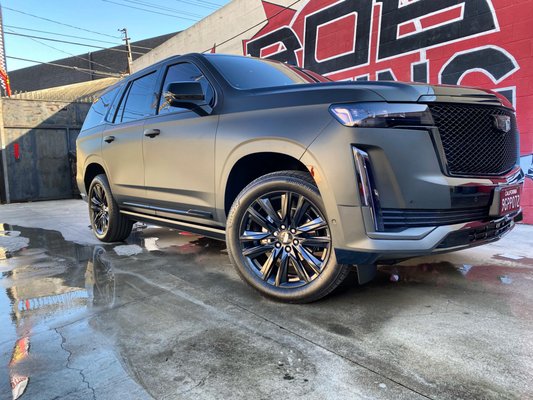 Photo of Rob's Glass Tinting - Culver City, CA, US. 2023 Cadillac Escalade wrap with 3M matte partial wrap, 3M crystalline,powder coated wheels & smoke smoke taillights/headlights