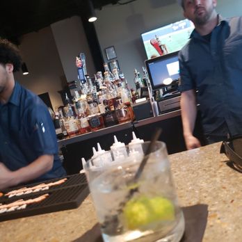 Pourhouse - two men sitting at a bar - Cocktail Bars Near Me - Huntsville, Alabama Pourhouse - two men sitting at a bar - Cocktail Bars Near Me - Huntsville, Alabama