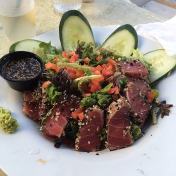 Caroline's - Yellowfin & Greens - Fresh tuna filet seared rare with roasted sesame seeds, baby lettuces, tomatoes, cucumbers & balsamic vinaigrette - American Near Me - Key West, Florida Caroline's - Yellowfin & Greens - Fresh tuna filet seared rare with roasted sesame seeds, baby lettuces, tomatoes, cucumbers & balsamic vinaigrette - American Near Me - Key West, Florida