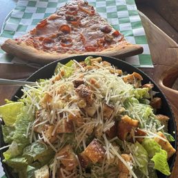One slice of pepperoni and Caesar salad. One slice of pepperoni and Caesar salad.