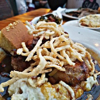 The Silver Dollar - Pork chop over a bed of mashed potatoes top with fried onions, gravy, and corn bread - Southern Near Me - Louisville, Kentucky The Silver Dollar - Pork chop over a bed of mashed potatoes top with fried onions, gravy, and corn bread - Southern Near Me - Louisville, Kentucky
