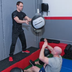 Top Level Fitness - Workouts are more fun at Top Level Fitness with trainers that help you during sets