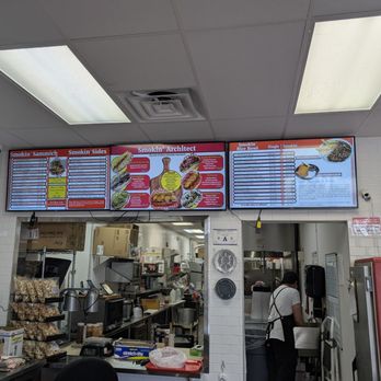 Smokin' Sammich - Inside is very neat and warm, of course they have the TV menu system so you can see all the wonderful choices. - Smokehouse Near Me - Las Vegas, Nevada Smokin' Sammich - Inside is very neat and warm, of course they have the TV menu system so you can see all the wonderful choices. - Smokehouse Near Me - Las Vegas, Nevada