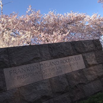Trip Hacks DC Tours - FDR Memorial with the Cherry Blossoms in the background. - Walking Tours Near Me