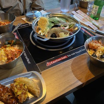 Dookki - Houston - Side dishes or rice + toppings along with fried snacks and the hot pot before cooking - Korean Near Me - Houston, Texas
