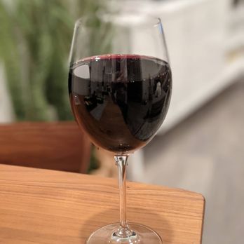 Bienmesabe - a glass of red wine on a table - Venezuelan Near Me - Chicago, Illinois Bienmesabe - a glass of red wine on a table - Venezuelan Near Me - Chicago, Illinois