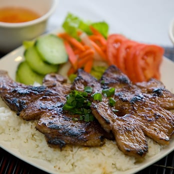 Ha Long Pho Noodle House - BBQ Pork Chops with White Jasmine Rice, Salad, Cucumbers, Tomatoes, Pickled Carrots and Daikong, served with Nuoc Mam and Pho Broth - Vietnamese Near Me - Honolulu, Hawaii Ha Long Pho Noodle House - BBQ Pork Chops with White Jasmine Rice, Salad, Cucumbers, Tomatoes, Pickled Carrots and Daikong, served with Nuoc Mam and Pho Broth - Vietnamese Near Me - Honolulu, Hawaii