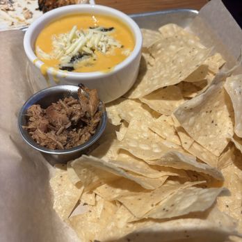 Twin Peaks - Chips and queso with brisket chili - Sports Bars Near Me - Columbia, South Carolina Twin Peaks - Chips and queso with brisket chili - Sports Bars Near Me - Columbia, South Carolina