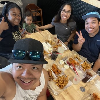 Fire Wings - Pittsburg - Family feasting on to much amazing wings - Chicken Wings Near Me - Pittsburg, California
