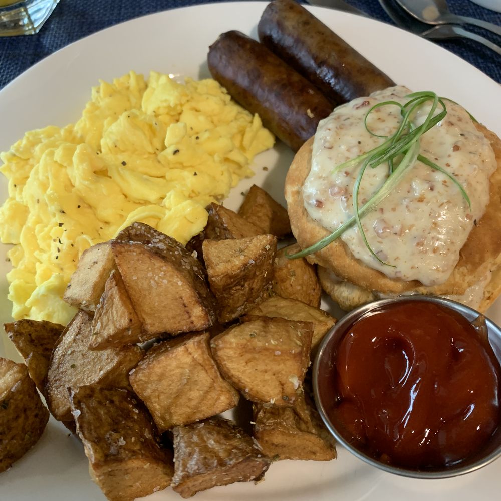 The Eye Opener - Two Eggs any style, Breakfast Potatoes or Grits, Applewood Bacon or Sausage and a Biscuit topped with Sausage Gravy. The Eye Opener - Two Eggs any style, Breakfast Potatoes or Grits, Applewood Bacon or Sausage and a Biscuit topped with Sausage Gravy.