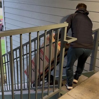 Diamond Moving - Mover carrying a box on a dolly up the stairs. - Movers Near Me - Vancouver, Washington