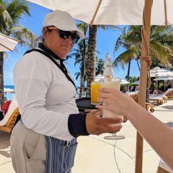 Grand Velas Riviera Maya - Grand Class (adults-only) pool-side service. My wife got a pina colada and I got an orange juice.