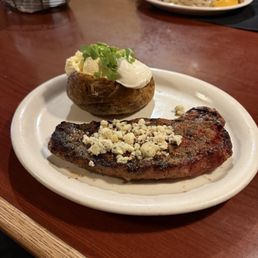 NY strip with baked potato and blue cheese topper
