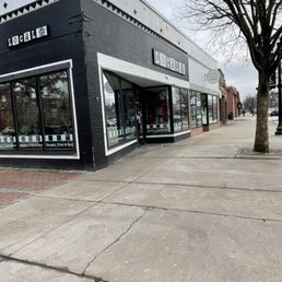 a black and white building on a street corner