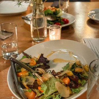 Good Luck Restaurant - a plate of salad on a wooden table - New American Near Me - Rochester, New York