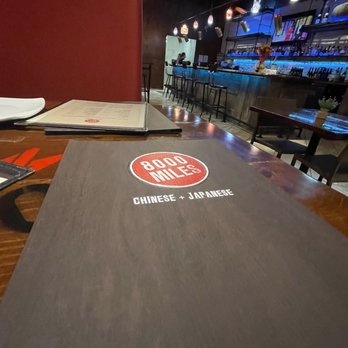 8000 Miles - a table with a pizza on it - Chinese Near Me - Roselle, Illinois