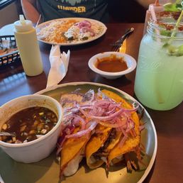 Quesabirrias (Orden De 3), pepinada, and COMBO Verdes Enchiladas on the far plate Quesabirrias (Orden De 3), pepinada, and COMBO Verdes Enchiladas on the far plate