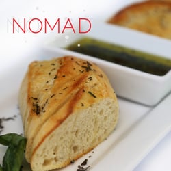 Nomad Kitchen and Lounge - HERBED OIL & VINEGAR SERVED WITH OUR WARM DEMI BAGUETTE barrel aged vinegar & extra virgin olive oil infused with seasonal herbs.