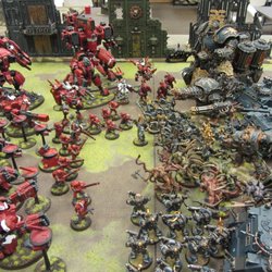 Tau Empire and Chaos Space Marines fight it out on the table top!