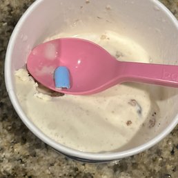a spoon in a bowl of ice cream